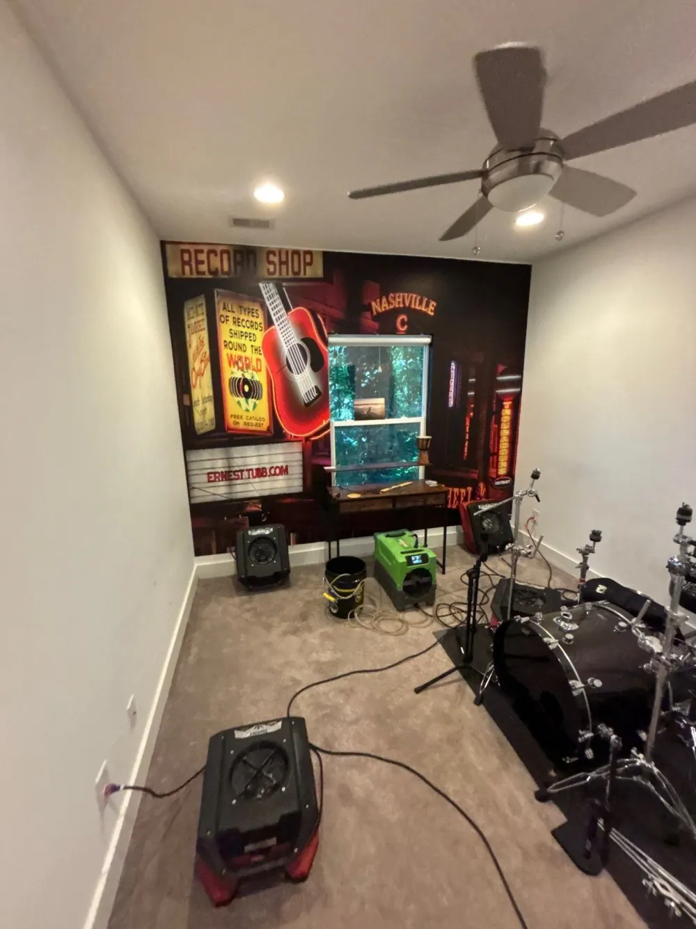 Commercial dehumidifier and air movers drying a Nashville room after water damage